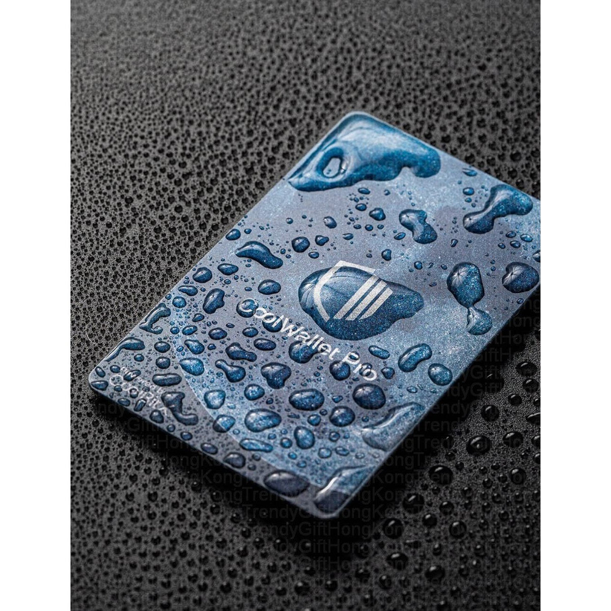 CoolWallet Pro — card-sized hardware device covered in water droplets, dark perforated background