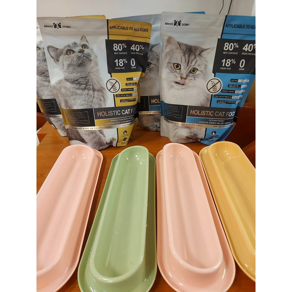 Bravo Dobby cat food bags displayed behind pastel feeding trays
