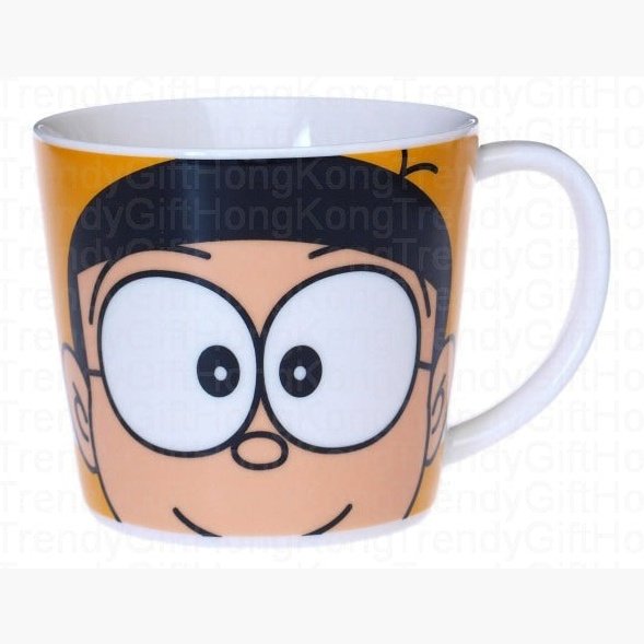Close-up of Nobita character artwork on the orange ceramic mug