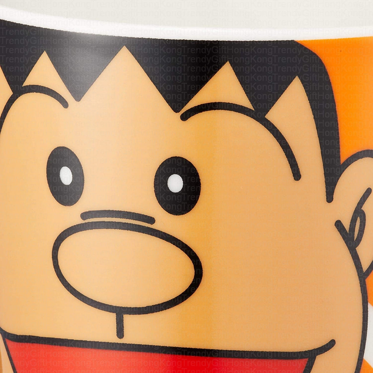 Close-up of Gian character artwork on the orange ceramic mug