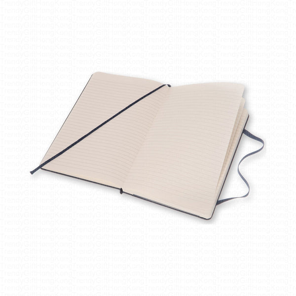 Open navy Moleskine notebook showing ruled pages and elastic closure