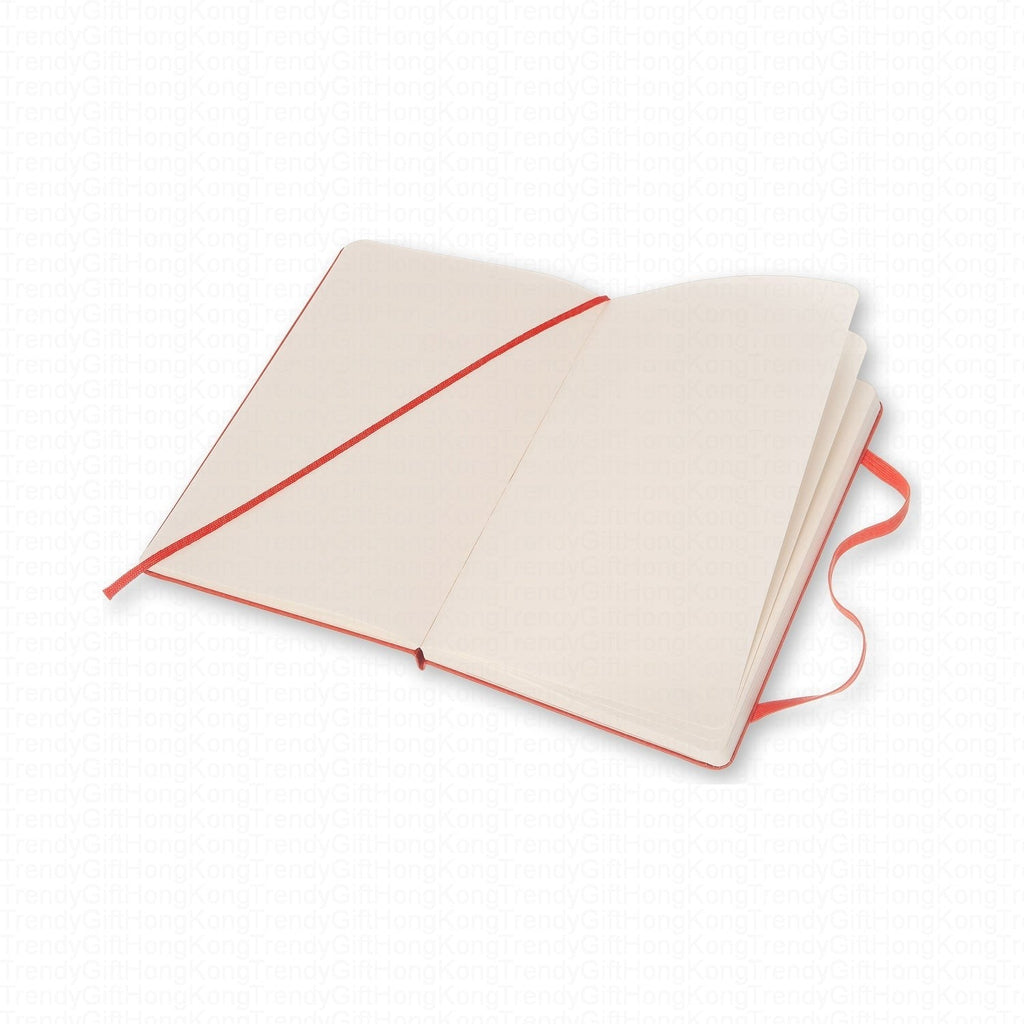 Open red Moleskine notebook with ruled pages and diagonal elastic