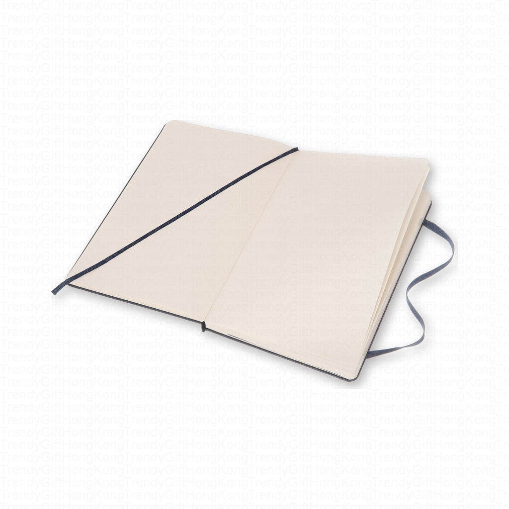 Open navy Moleskine notebook showing a lined spread and elastic closure