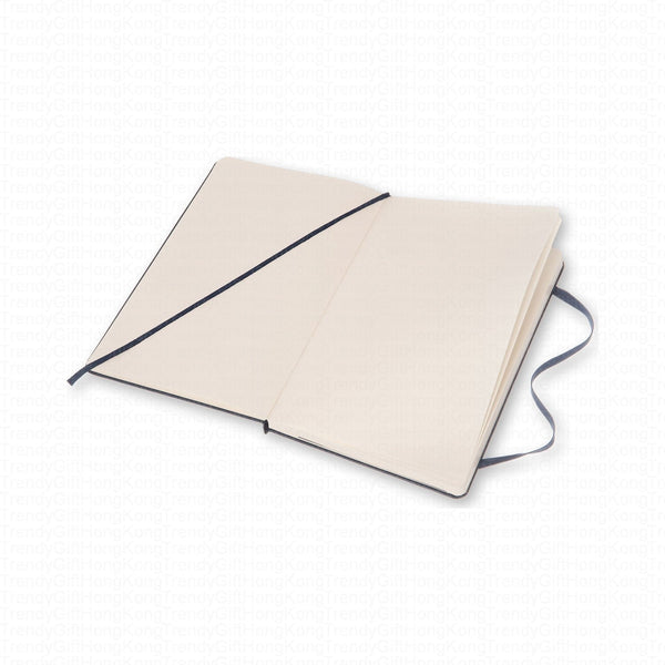 Open navy Moleskine notebook showing a lined spread and elastic closure
