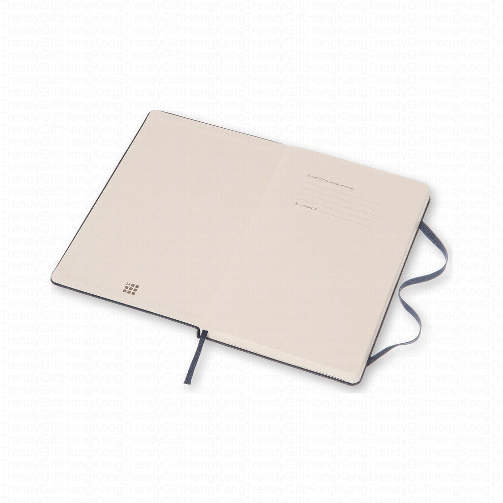 Navy Moleskine notebook laid flat with its pale rear cover facing up