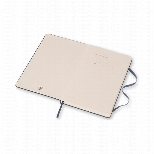 Navy Moleskine notebook laid flat with its pale rear cover facing up