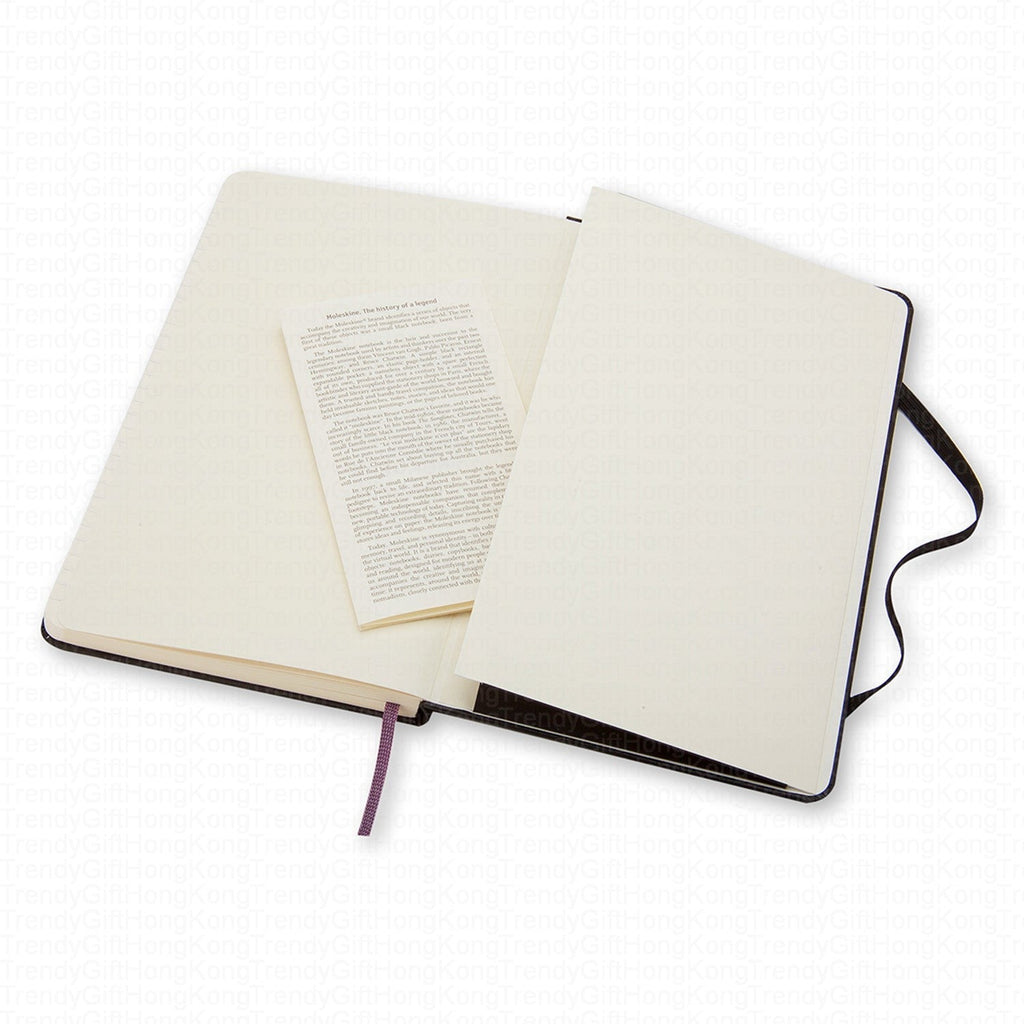 Black Moleskine notebook opened beside a printed information leaflet