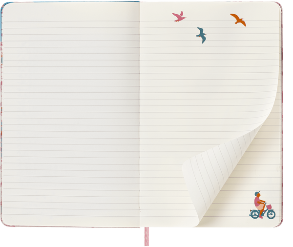 Open ruled Moleskine Sakura notebook with bird and cyclist illustrations and a turned page.