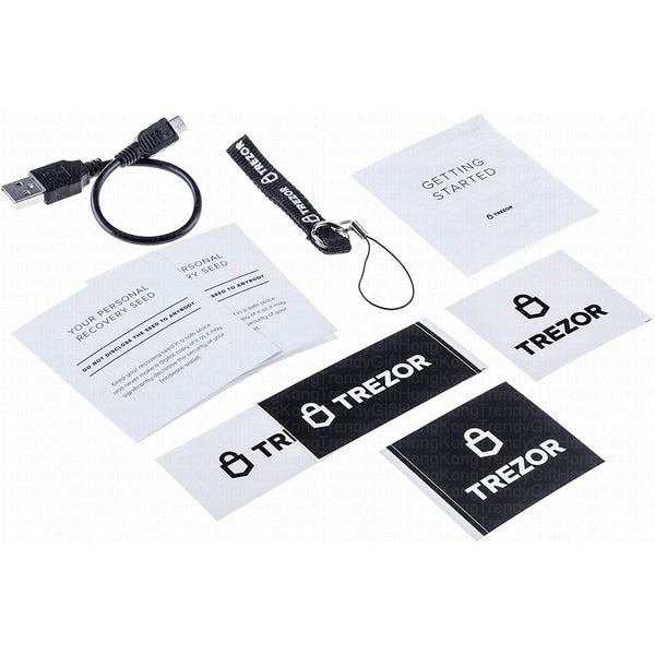 Trezor Model One — cable, strap, two recovery cards, a getting started guide and logo stickers laid out