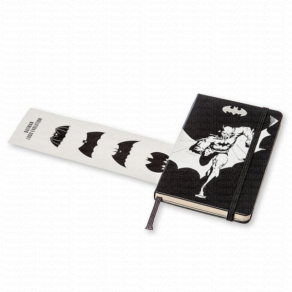 Moleskine Batman notebook beside its themed illustrated paper band
