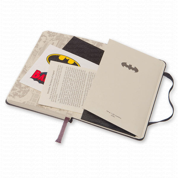 Open Batman notebook showing the themed inner cover, sticker and expandable pocket